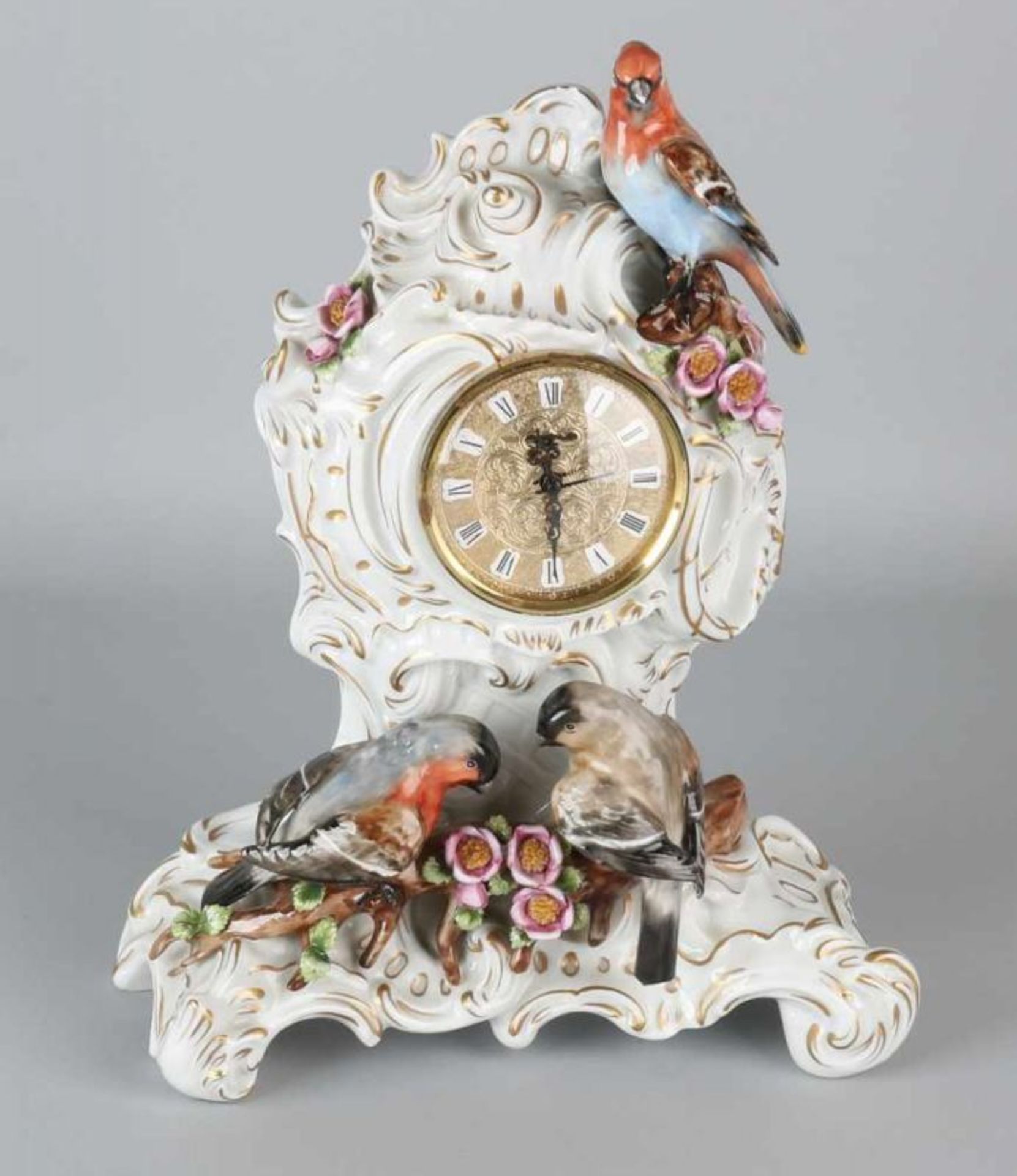 German porcelain clock. Marked with a crown and 1882. Decorated with gold decor, birds, flowers.