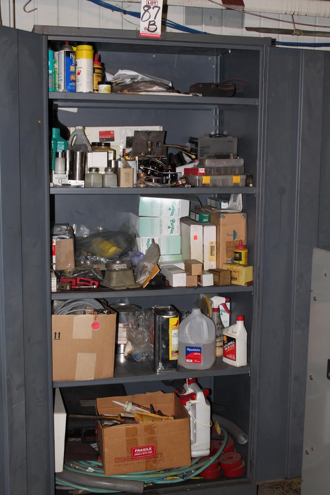 2-DOOR STORAGE CABINET WiTH CONTENTS OF SUPPLIES FOR THE CNC LASERS