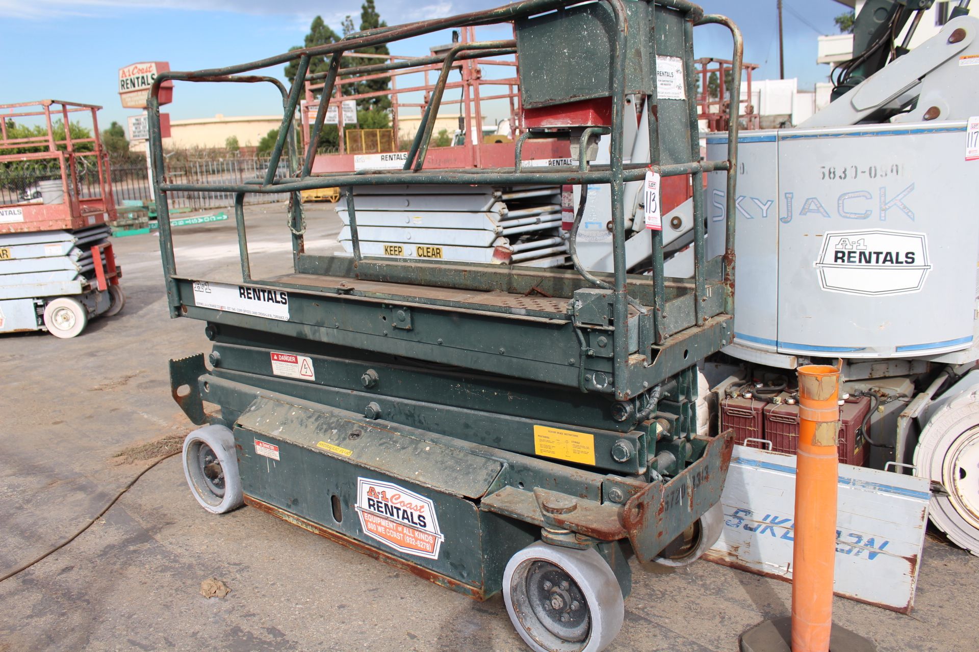 SCISSOR LIFT 90" X 24" PLATFORM, HAS BATTERIES AND IS SAID TO RUN