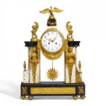 GILDED BRONZE PORTAL PENDULUM CLOCK LOUIS XVI. Paris. Ca. 1780. White and black marble. Gilded