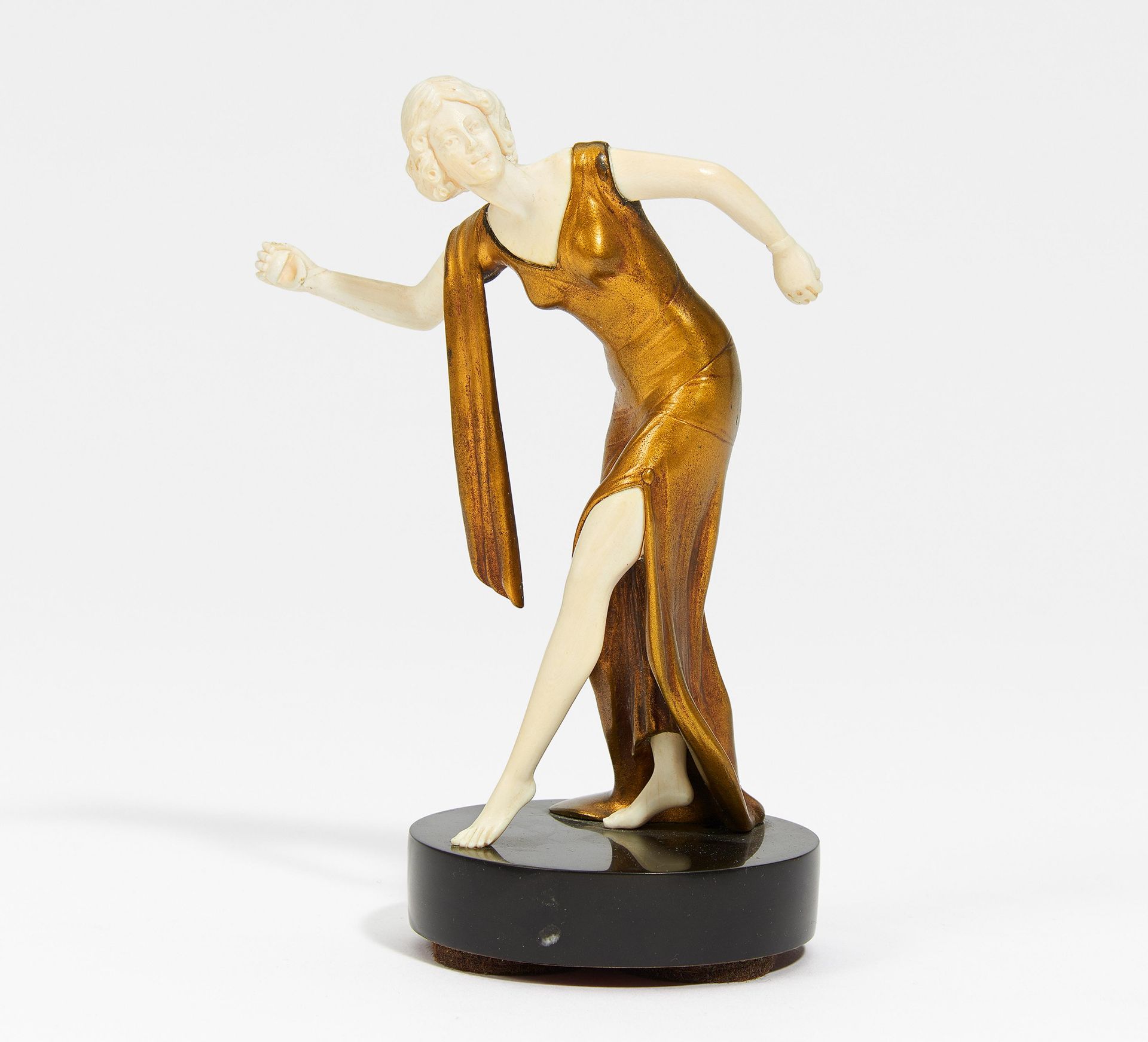 FIGURINE OF DANCING GIRL WITH CASTANETS MADE OF IVORY AND GILDED BRONZ ON STONE PEDESTAL. Ca. 1920s.
