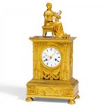 GILDED BRONZE PENDULUM CLOCK "THE MUSIC LESSON". Paris. Ca. 1800-'15. Gilded bronze. Enamel dial.