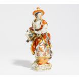 zurückgezogen / withdrawn---PORCELAIN FIGURINE OF A MALABAR LADY WITH HURDY-GURDY. Meissen. Model