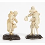 TWO LARGE FIGURINES OF BEGGARS CARVED IN IVORY ON WOODEN PEDESTALS. Germany. 19th century. Ivory