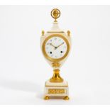 GILDED BRONZE PENDULUM CLOCK VASE-SHAPED. Paris. Ca. 1800. White marble. Gilded bronze. Enamel dial.