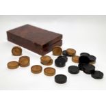 23 BAROQUE FRUITWOOD TOKENS. South Germany. 18th century. Fruitwood partly ebonised. Eleven dark and