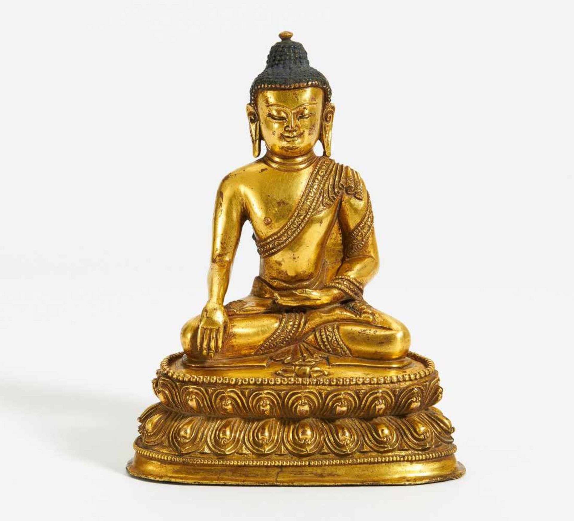 BUDDHA AKSHOBHYA WITH VAJRA. Sino-Tibetan. Copper bronze with fire gilding and blue pigments. W.