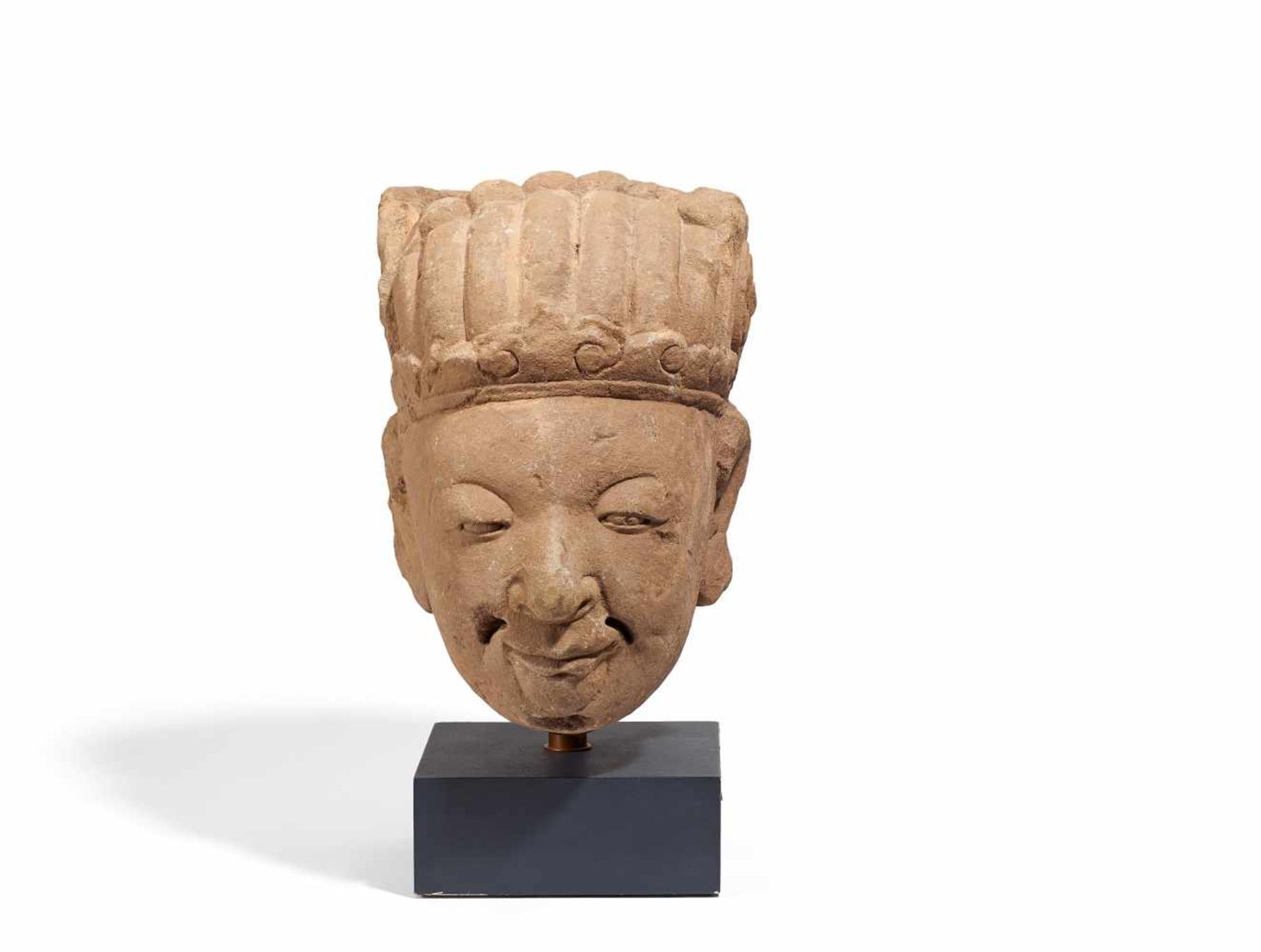 HEAD OF WENCHANG. China. Ming dynasty (1368-1644). Pink sandstone. The courtly headgear suggests