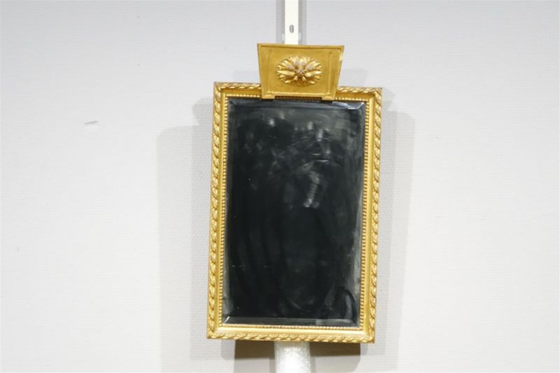 spiegeltje met goudbeschilderde geprofileerde rand en bekroond door een rozet, 19e eeuw, h. 55,