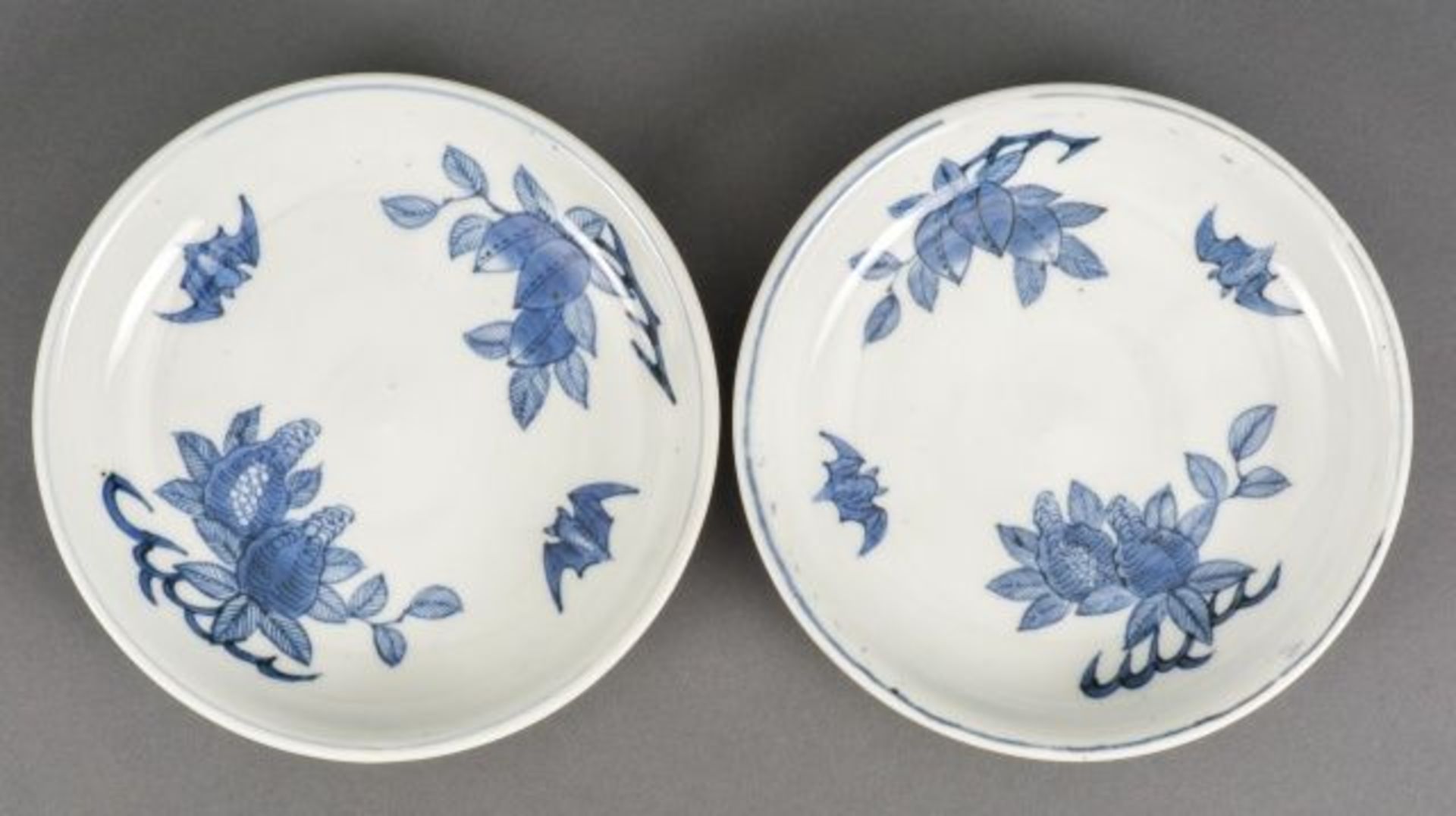 Pair of blue and white porcelain Arita plates with pomegranate and bat motif, Japan, signed Dai