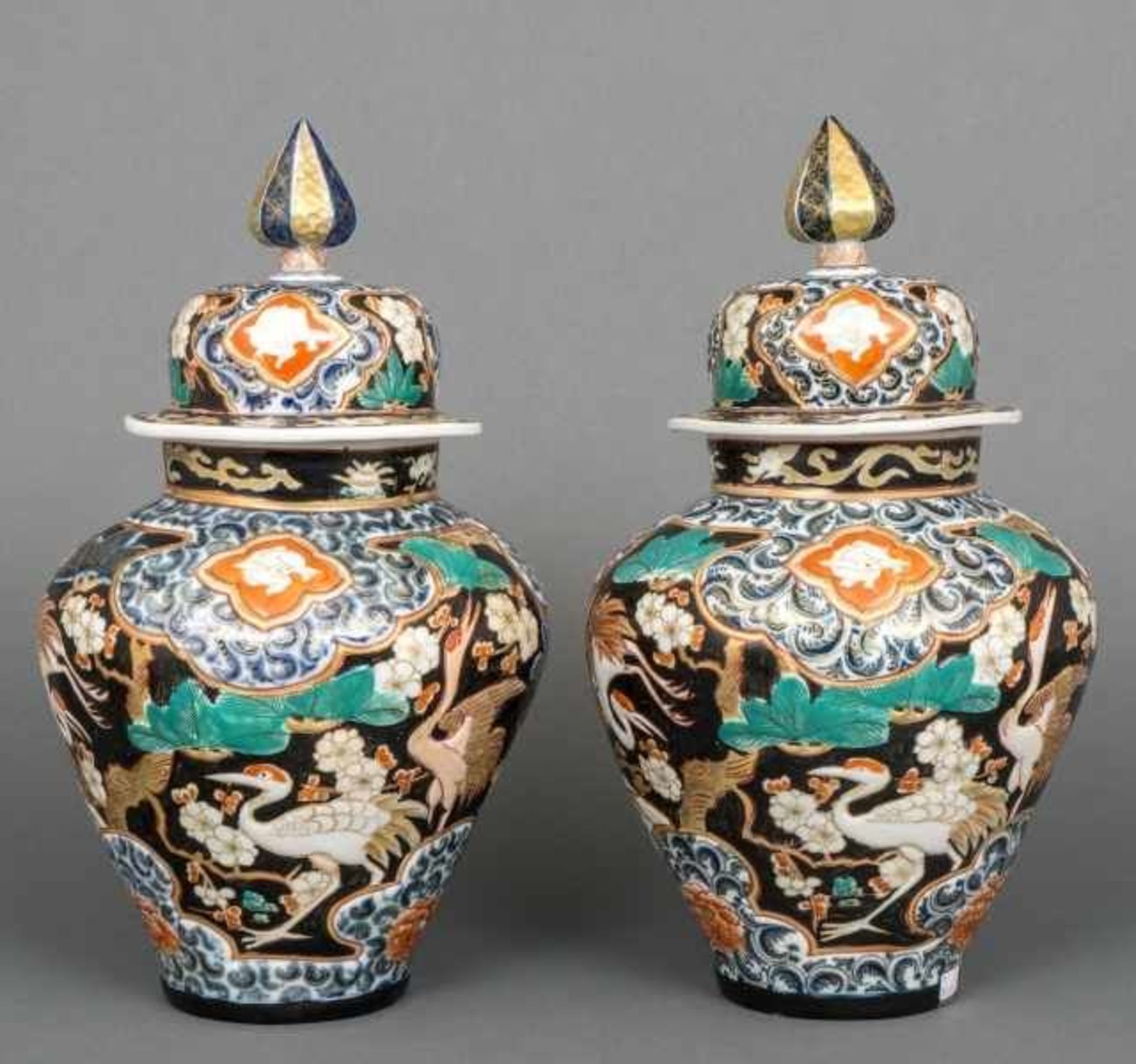 Pair of moulded Imari porcelain baluster vases and covers decorated with cranes and rabbits,