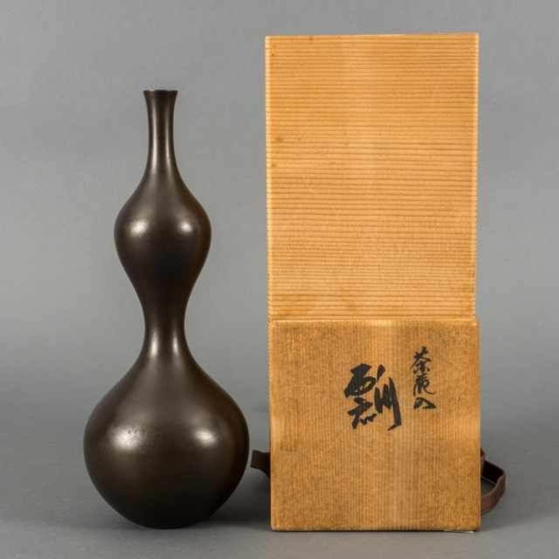 Dark brown patinated bronze double gourd vase, Japan, signed Kaneharu, second half 20th century,