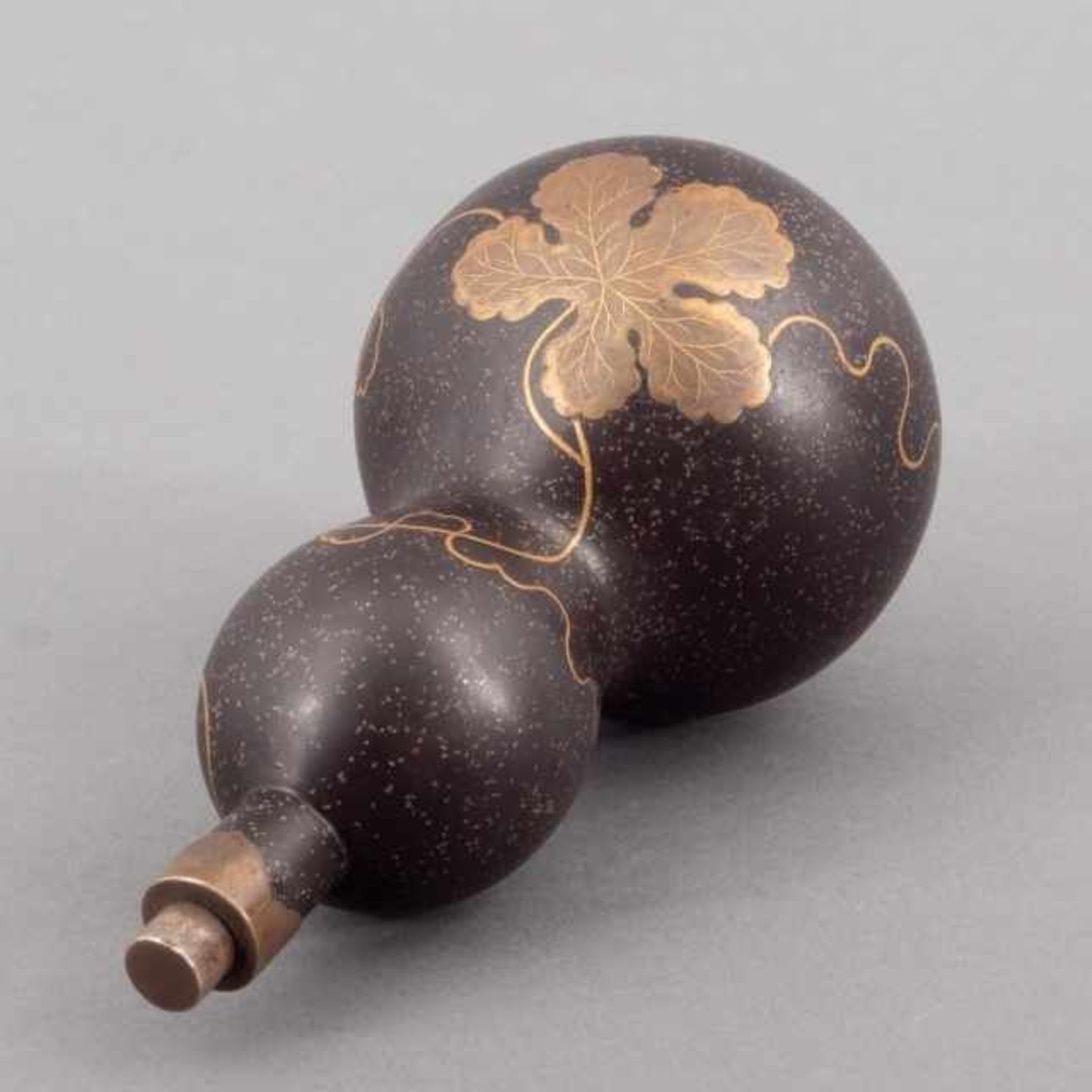 Black lacquer double gourd sake flask with golden takamaki-e motif of gourd vines, the mouth and