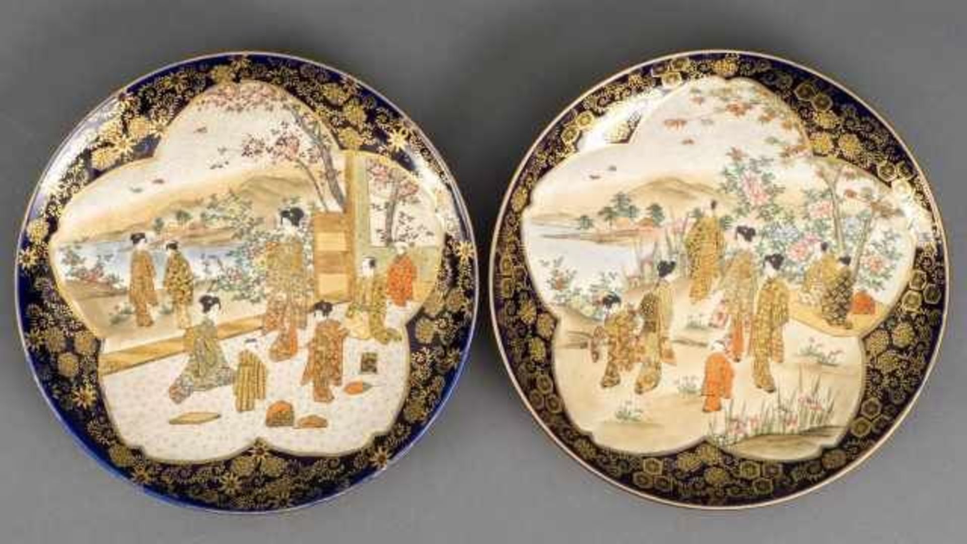 Pair of Satsuma plates decorated with figures in a flower shaped cartouche, around it a cobalt