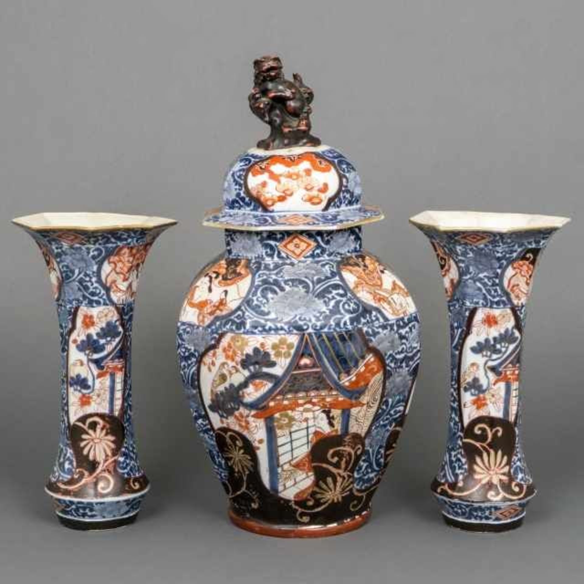 Three-piece porcelain Imari garniture with partial black enamel and decorated with bijin in