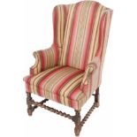 Een oorfauteuil, 1e helft 20e eeuw.Met getorste regels. Afm. 120 x 80 x 60 cm.A wing chair, first