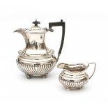 An English silver coffeepot and milkjug. Hallmarked Birmingham. Maker's mark Barker Brothers. Year