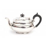 An English silver teapot. Maker's mark Sydney Hall & Co. Year letter 1932-1933. With a wooden