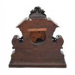 A large oak mantle clock decorated with wild strawberries, acanthus leaves and volutes. The