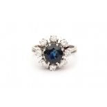 A 14 krt white gold entourage ring. 60's- 70's. Set with mixed cut heat treated sapphire, ca. 2.00