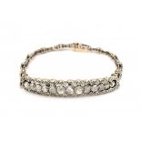 A 14 krt yellow gold and silver bracelet with stiff centre piece. Set with rose cut diamonds.