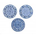 A set of three Chinese blue and white plates, decorated with flowers. Marked with a flower symbol.