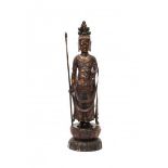 A bronze eleven headed Guanyin, standing on a lotus throne holding a staff and a phial. With a