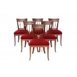 A set of six mahogany dining chairs. Ca. 1830. With brass stringing inlay. All chairs with a paper