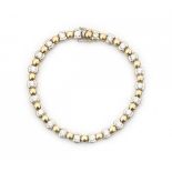 A bracelet with alternating 18 krt white and yellow gold links. The 22 white gold links are set with