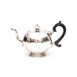 An Irish sterling silver teapot. Maker's mark Royal Irish Silver Co. Year letter 1974. With a wooden