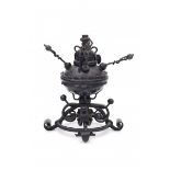 A wrought iron oil lamp and lighter with four detachable individual lighting sticks. Circa