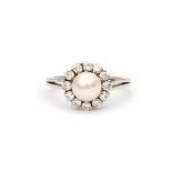 A 14 krt white gold entourage ring. Set with pearl, diameter ca. 6.9 mm and brilliant cut