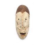 A wooden part pigmented mask. Lega tribe, Bwami, D.R. CongoLengte 26 cm.