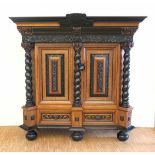 A Dutch oak and rosewood cabinet, richly ornamented with pillars and carved ornaments. Circa