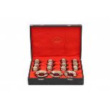 A Satsuma mocca set in a case, comprising of twelve cup and saucers. The case with adres: K.A.J.