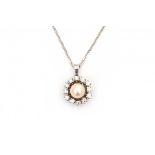 A 14 krt white gold chain link necklace with pendant. Pendant set with a cultivated pearl,