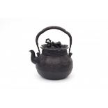 A Japanese cast iron water pot, in the shape of a tied burlap sack. Marked on the handle. Meiji
