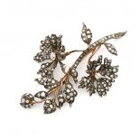 A 18 krt red gold and sterling silver flower brooch. Austrian. In part en tremblant. Set with old