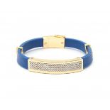 A flexible blue rubber bracelet with 18 krt yellow gold elements. Gold detailing is set with