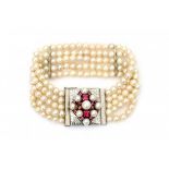 A bracelet with five strings cultivated pearls and a 14 krt white gold lock. Lock set with synthetic