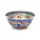 A Chinese 'clobbered' bowl, decorated with immortals and the inside with a dragon. 18th