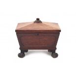 A mahogany wine cellaret. 19th century. With hinged cover enclosing a lead-lined 8 bottle