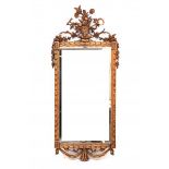 A mirror in gilt frame, crowned with a basket of flowers. Circa 1800127 x 57 cm.