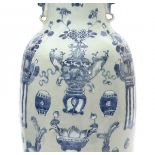 A Chinese vase, decorated in underglaze blue with incense burners, tables, fruit and flowers on a