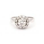 A 14 krt white gold entourage ring. Set with brilliant cut diamonds. Central diamond, ca. 0.90 ct,