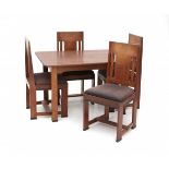 Haagse StijlAn oak and ebonised wooden dining table with four chairs, in the style of Jan Brunott (