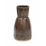 Ryozo Miki (1942)A black and brown glazed ceramic vase, facetted form with cylindrical top rim,