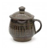 Michael Cardew (1901-1983)A stoneware small pitcher with lid, decorated with linear pattern,