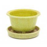 A.D. Copier (1901-1991)A circular yellow 'Graniver' flowerpot on coaster, model Walu, produced by