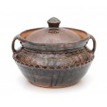 Michael Cardew (1901-1983)A brown glazed stoneware 'Gwari' casserole with two loop handles,